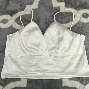 Satin tank top. Very cute and adjustable in the back.